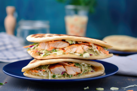 pita bread sandwich packed with coleslaw on blue table, created with generative aiの素材