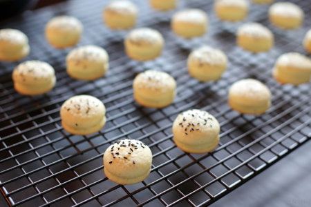 macaron shells cooling on a wire rack, created with generative aiの素材
