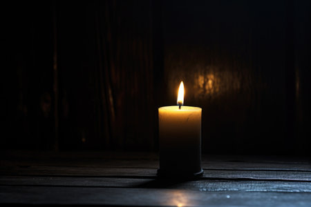 a dark room lit only by a flickering candle, created with generative aiの素材