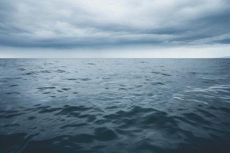 ocean surface under a grey cloud, created with generative aiの素材