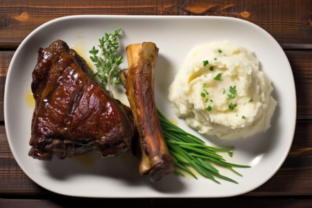 overhead shot of pork ribs served with a side of mashed potatoes, created with generative aiの素材