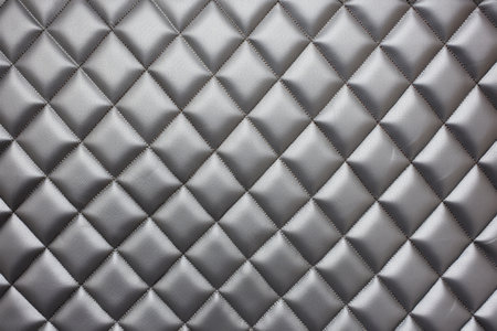 close snapshot of a quilted vinyl in grey, created with generative aiの素材