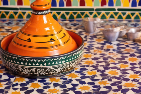 moroccan tagine pot on a vibrant tiled table, created with generative aiの素材