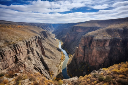 dramatic view of a rugged canyon with river below, created with generative aiの素材
