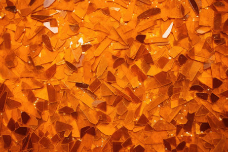 dark orange glitter randomly scattered over an orange surface, created with generative aiの素材