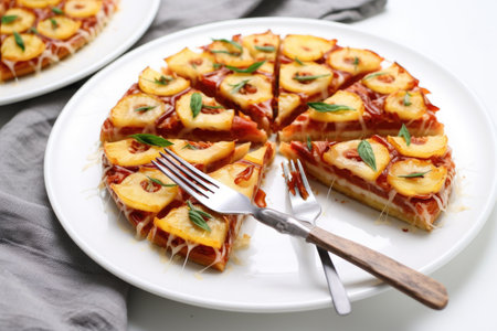 pineapple pizza slices arranged radially on a white plate with a silver fork, created with generative aiの素材