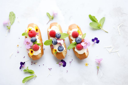 eclairs with berries and mint leaves on topの素材