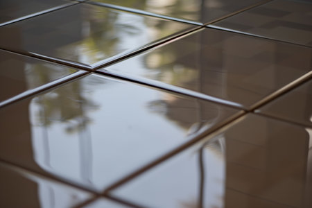 closeup of shiny ceramic floor tiles with reflectionの素材