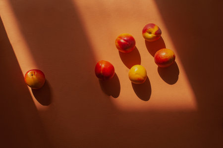 Top down flat lay orange colorful shot peaches and shadow summer food concept