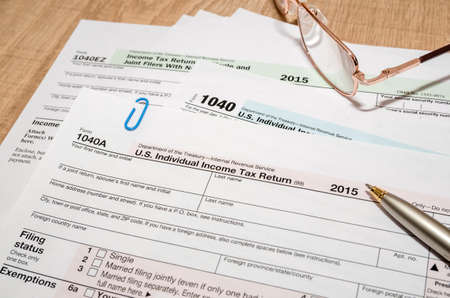 1040 US tax form for 2016 year with pen and glassesの写真素材