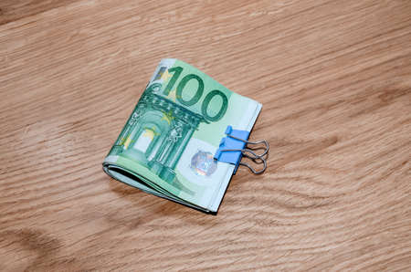 one hundred euro money banknotes on wooden plankの写真素材