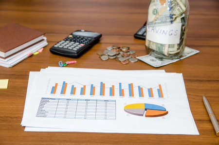 business concept - graph with money, calculator and penの写真素材