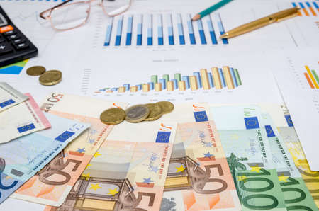 Financial concept with euro bills, calculator, graph and penの写真素材