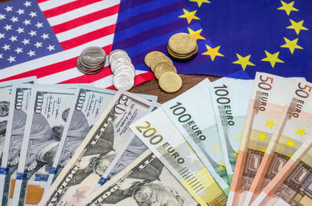 Dollars and euro with flag in tableの写真素材