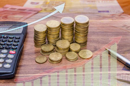coin with calculator on tableの写真素材