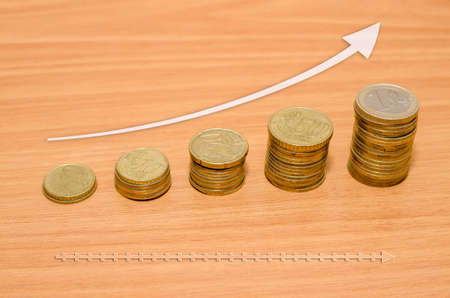 Euro coins with arrowの写真素材