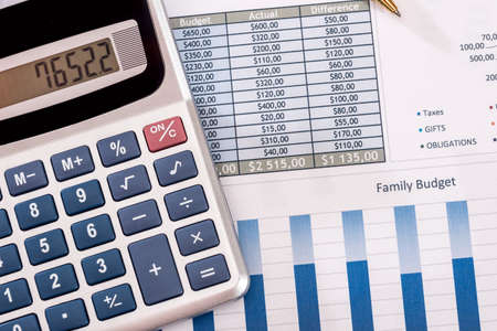 business chart with calculator and pen.