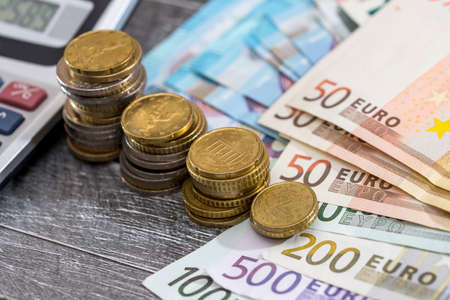 business concept - calculator with euro coin and banknotes.の写真素材