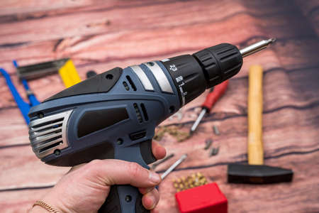 screwdriver with drill and screw on wooden desk.の写真素材