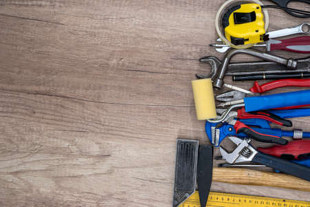 Old tools on wooden background. Top view.