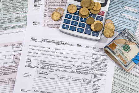 tax concept - form, money, calculator and pen.の写真素材