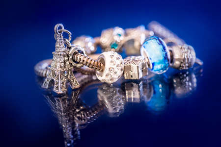 bracelet mix precious stones and beads isolated on dark blue.の写真素材