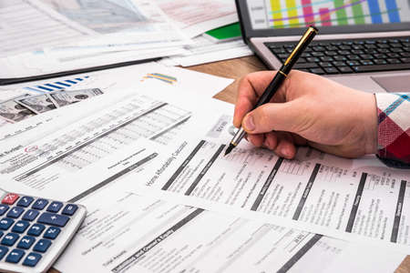 businessman making report, calculating or checking balance.の写真素材