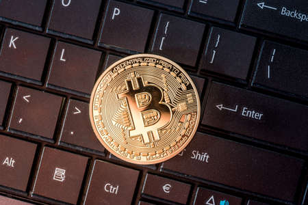 gold bitcoin coin on the keyboard. close upの写真素材