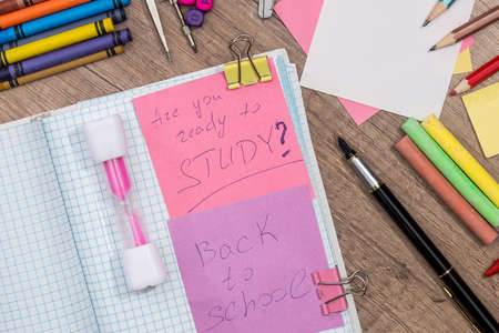 text back to school with school supplies on desk