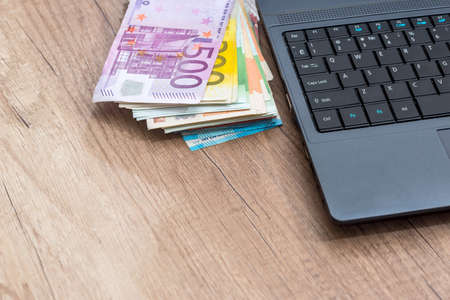euro money with laptop on the tableの写真素材