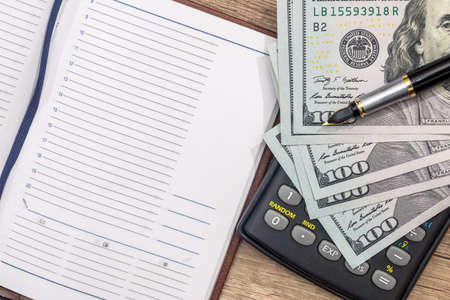 empty notepad, pen, doolar and coin on desk
