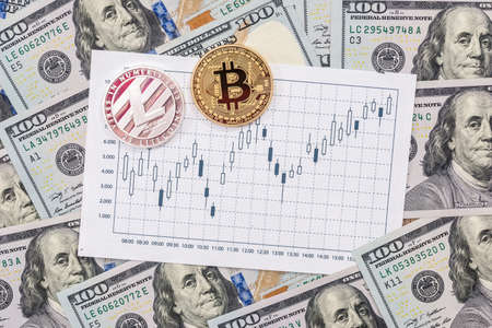 golden bitcoin, silver litecoin with dollar and graph backgroundの写真素材