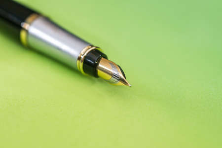 pen isolated on green background. Office equipment for paperwork.