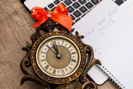 old clock with notepadの写真素材