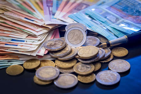 euro coin and banknote isolated on black background