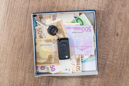 euro banknote with car key in box on deskの写真素材