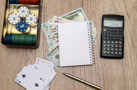 casino chips in suitcase with us money, cards, notepad