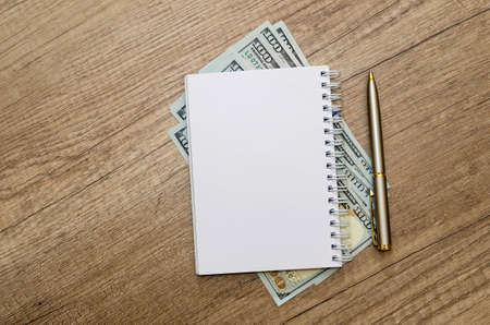Opened Empty Notepad With Pen And Dollar Cashの写真素材