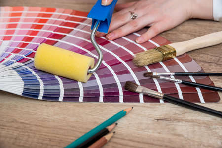 woman hand pointing to color samples