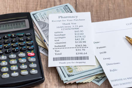 receipt and blank prescription calculator, money on desktopの写真素材