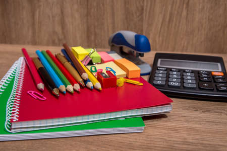 many school supplies on wooden backgroundの写真素材