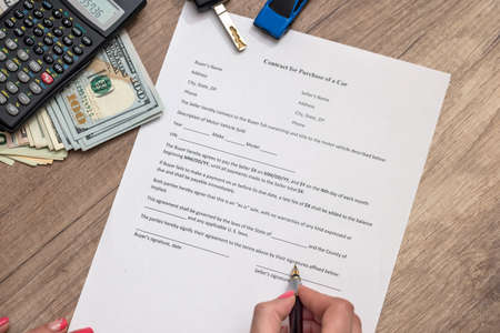 car contract form with money, pen, keyの写真素材
