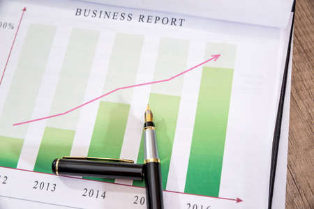 business graph with a pen on dollar.