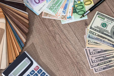 wooden sampler with money on desk.