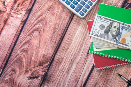 Home savings - notepad, dollars on desk.の写真素材