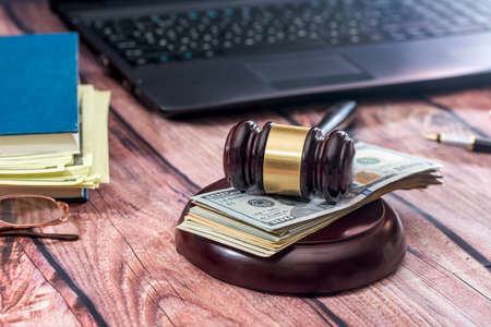 law concept - gavel, laptop, dollar on desk.の写真素材