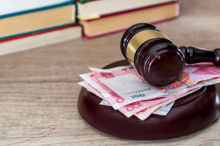 wooden gavel with yuan bills close up.の写真素材
