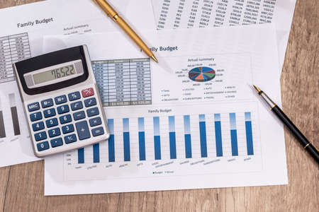 business chart with calculator and pen.