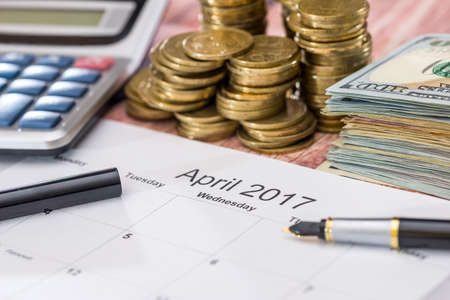 calendar, money, calculator and pen. tax concept. april.の写真素材