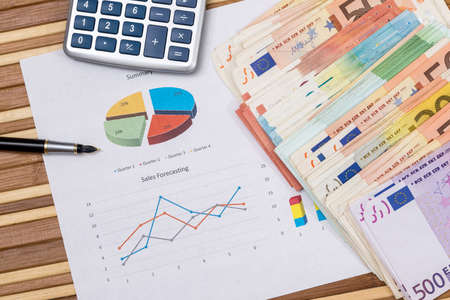 calculator, business graph with euro money on deskの写真素材